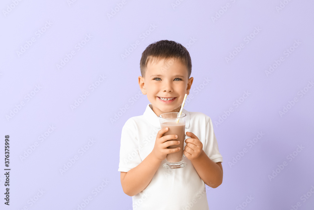 Little boy with tasty chocolate milk on color background