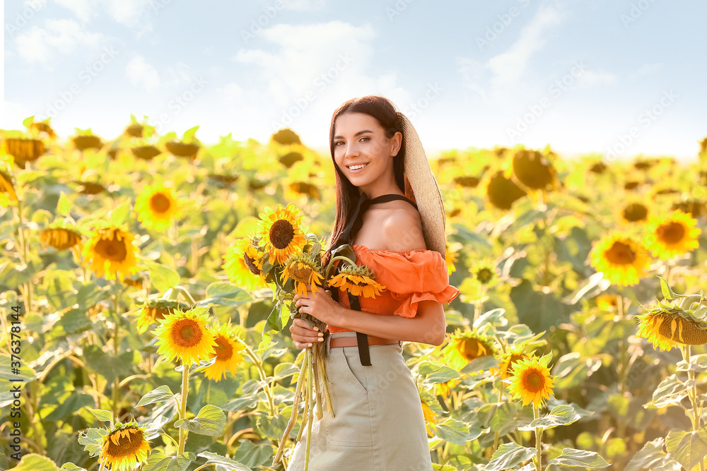 Beautiful young woman in sunflower field