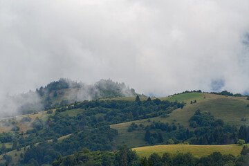 Poster - Majestic view on beautiful fog and cloud mountains in mist landscape.