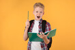 © Prostock-studio - Teenage boy holding notebook and raising pen up at studio