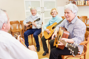 Wall Mural - Group of seniors takes guitar lessons in VHS