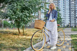 © Svitlana - Fashionable adult lady in denim jacket stoping riding her bike