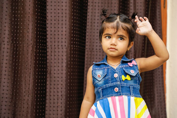 Wall Mural - Cute Indian girl child showing cute expression