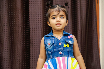 Wall Mural - Cute Indian girl child showing cute expression