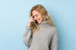 © luismolinero - Young blonde woman wearing a sweater isolated on blue background laughing