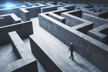 Poster - Businessman standing in middle of a concrete  labyrinth