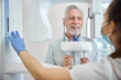 Professional dentist in charge of a panoramic dental x-ray machine