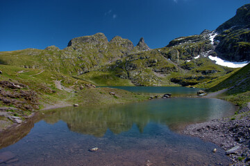 Wall Mural - Kleiner Bergsee auf dem Pizol in der Schweiz 7.8.2020