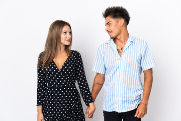 Young caucasian couple isolated on white background holding hands