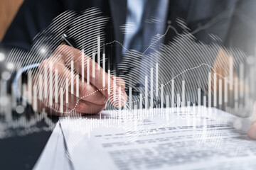 Businessman in suit signs contract. Double exposure with forex graph hologram. Man signing brokerage agreement. Financial market analysis and investment concept.