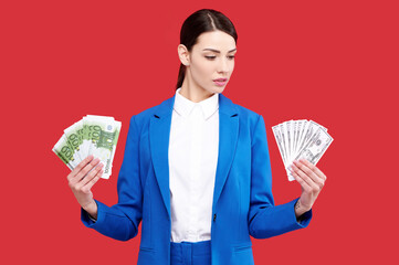 Wall Mural - European business woman in blue suit holding euro and dollars banknotes, female with wad of money or cash, isolated background