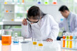 © narong - Lovely little girl enjoy to examine the color chemical in laboratory with day light. Concept of good practice and education of science for children support their learning.