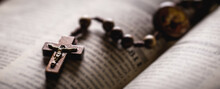 Christian Wooden Crucifix On Open Bible, Point Focus. Religious Concept Image