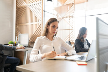 Wall Mural - Businesswoman writing notes on notepad