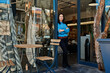 © mavoimages - Young Asian entrepreneur standing at the entrance of her store