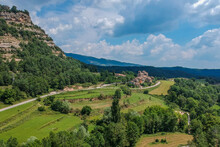 Panorama Of A Village Sant Jaume De Frontanya With Church Visible In The Middle. Beautiful Catholic Church In The Middle Of Catalunyan Or Spanish Countryside On A Sunny Day.