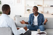 © Prostock-studio - Successful Therapy. Cheerful black man talking to psychologist at his office