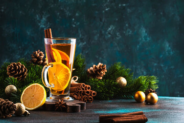 Christmas or New Year hot winter drink, spicy grog cocktail, punch or mulled wine with tea, lemon, rum, cinnamon, anise. Rustic style, festive table setting, copy space