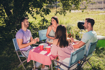 Poster - Four nice attractive glad cheerful cheery guys group meeting talking eating lunch dinner snack spending weekend free spare time enjoying rest chill sunny day village holiday