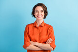 Fototapeta  - Photo of attractive bossy lady bobbed hairdo arms crossed self-confident person worker friendly smile white teeth good mood wear orange office shirt isolated blue color background
