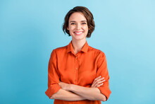 Photo Of Attractive Bossy Lady Bobbed Hairdo Arms Crossed Self-confident Person Worker Friendly Smile White Teeth Good Mood Wear Orange Office Shirt Isolated Blue Color Background