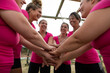 © Wavebreak Media - Group of woman stacking hands together at boot camp