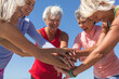 © Wavebreak Media - Group of woman stacking hands together