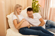 © Inna Vlasova - happy man hugging pregnant woman at home