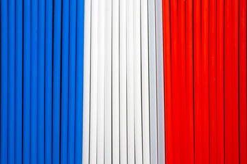 Wall Mural - top view of blue, white and  red plastic straws in a row