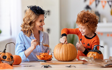 Wall Mural - happy family mother and son laughing and getting ready for Halloween.