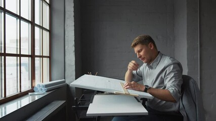 Poster - Young engineer with construction plan in office