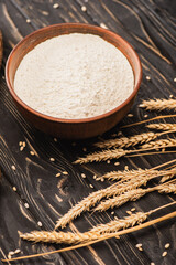 Sticker - wheat flour in bowl and spikes on wooden surface