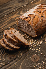 Sticker - cut fresh baked bread with seeds on wooden surface