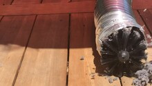 Rotating Brush On Drill Cleaning Lint Buildup In Dryer Vent Pipe