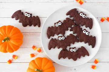 Aufkleber - Halloween bat cookies, above view with pumpkins on a white wood background