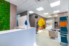 The Combination Of The Modern Office Interior With The Natural Elements - Wooden Panels And The Moss Wall. The Waiting Area With Advertising Stands, And The Play Space For Children
