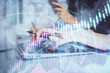 © peshkova - Multi exposure of woman hands typing on computer and financial graph hologram drawing. Stock market analysis concept.