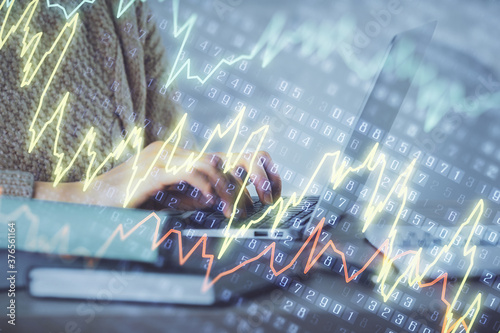 Fotomural Double exposure of woman hands typing on computer and forex chart hologram drawing