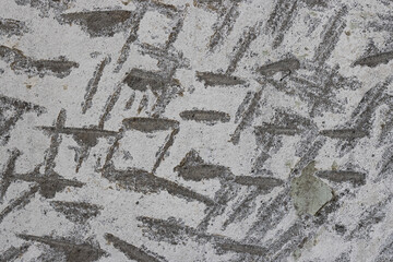 Texture of old concrete wall. Rough gray surface of concrete with a chaotic pattern of potholes and scratches. Perfect for background and design. Close-up. High resolution.