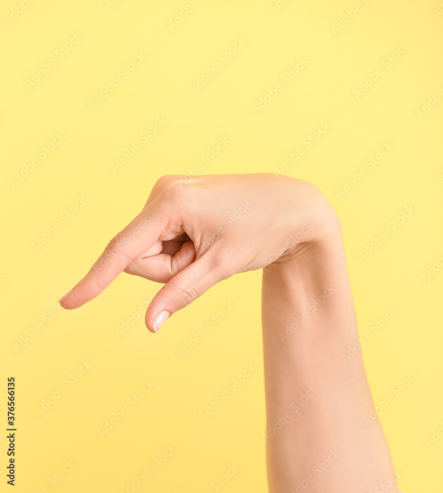 Hand showing letter Q on color background. Sign language alphabet