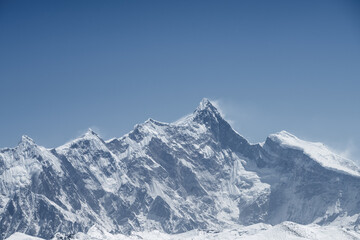 Wall Mural - mountain peak against a blue sky