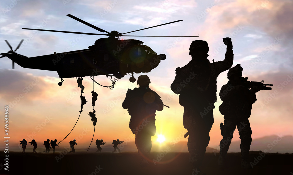 silhouette  of military operation at sunset - obrazy, fototapety, plakaty 
