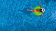© Iuliia Sokolovska - Beautiful woman in hat in swimming pool aerial view from above, young girl in bikini relaxes and swims on inflatable ring donut and has fun in water on vacation
