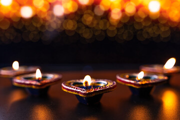 Wall Mural - Indian festival Diwali, Diya oil lamps lit on colorful rangoli. Hindu traditional. Happy Deepavali. Copy space for text.