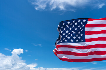 Wall Mural - Waving USA flag under blue sky background.