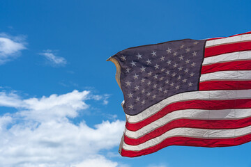 Wall Mural - Waving USA flag under blue sky background.