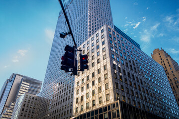 Looking up at Manhattan intersection wit h straffic lights at 42nd street and 3rd ave business buildings and skyscrapers