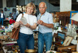 © JackF - Elderly couple in flea market chooses antique items. High quality photo