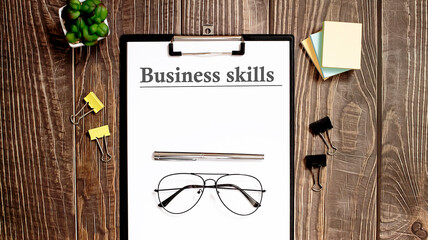 Poster - business skills form on a wooden table.