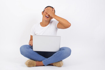 Wall Mural - Happy Caucasian young woman closing eyes with hand going to see surprise prepared by boyfriend standing and smiling in anticipation for something wonderful. Young lady covering face with hand.